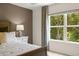 Cozy bedroom featuring a large window and a bedside table at 349 Sound Cir, Stockbridge, GA 30281