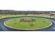 Community roundabout featuring a manicured green space with a fountain and young trees at 349 Sound Cir, Stockbridge, GA 30281