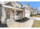 Inviting front porch of charming craftsman home with stone exterior and landscaping at 193 Cottontail Ln, Loganville, GA 30052