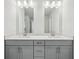Double vanity bathroom with modern light fixtures at 4745 Marjorie Dr, Cumming, GA 30041