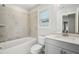 Clean bathroom with a tub, toilet and gray vanity at 4745 Marjorie Dr, Cumming, GA 30041