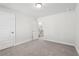 Well-lit bedroom with grey carpet and neutral walls at 4745 Marjorie Dr, Cumming, GA 30041