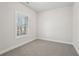 Well-lit bedroom featuring gray carpet and large window at 4745 Marjorie Dr, Cumming, GA 30041