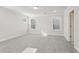 Bedroom with gray carpet, multiple windows, and a door to the bathroom at 4745 Marjorie Dr, Cumming, GA 30041