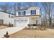 Two-story house with white siding, a gray stone base, and a two-car garage at 4745 Marjorie Dr, Cumming, GA 30041
