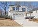 Two-story house with white siding, a gray stone base, and a two-car garage at 4745 Marjorie Dr, Cumming, GA 30041