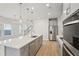 Modern kitchen with gray cabinets, stainless steel appliances and an island at 4745 Marjorie Dr, Cumming, GA 30041
