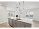 Open concept kitchen with island, stainless steel appliances, and hardwood floors at 4745 Marjorie Dr, Cumming, GA 30041
