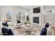 Living room with fireplace, white sofas, and a large TV at 4745 Marjorie Dr, Cumming, GA 30041