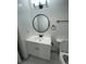 Modern bathroom vanity with round mirror and white countertop at 1678 Se Christian Cir, Conyers, GA 30013