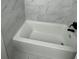 Clean bathroom with new bathtub and marble tile at 1678 Se Christian Cir, Conyers, GA 30013