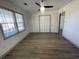 Spacious bedroom with ceiling fan, double-door closet, and wood-look flooring at 1678 Se Christian Cir, Conyers, GA 30013