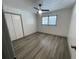 Bedroom with ceiling fan, window, closet, and wood-look flooring at 1678 Se Christian Cir, Conyers, GA 30013
