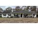 Ranch style home with white exterior, covered porch, and mature trees at 1678 Se Christian Cir, Conyers, GA 30013