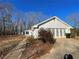 White brick ranch house with large backyard and trees at 1678 Se Christian Cir, Conyers, GA 30013