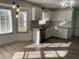 Updated kitchen with white cabinets, granite countertops, and stainless steel appliances at 1678 Se Christian Cir, Conyers, GA 30013