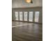 Bright living room with multiple windows and hardwood floors at 1678 Se Christian Cir, Conyers, GA 30013