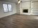 Living room features a brick fireplace, built-in shelves, and wood-look flooring at 1678 Se Christian Cir, Conyers, GA 30013