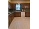 Galley kitchen with wood cabinets and white appliances at 4681 Mercer Rd, Stone Mountain, GA 30083