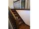 Wooden staircase with brown carpeting and wooden railing at 4681 Mercer Rd, Stone Mountain, GA 30083