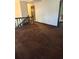 Upper level hallway with brown carpet and access to bedrooms at 4681 Mercer Rd, Stone Mountain, GA 30083