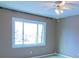 Bright bedroom with neutral walls, ceiling fan, and large window at 1818 Ashborough Cir # E, Marietta, GA 30067