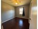 Bedroom with hardwood floors, neutral walls and a window with dark curtains at 4597 Karla Cir, Conley, GA 30288