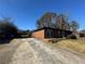 Brick ranch-style home featuring a long driveway and backyard with some grass at 4597 Karla Cir, Conley, GA 30288