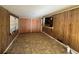 Cozy living room featuring wood paneling, a large window, and access to the kitchen at 4597 Karla Cir, Conley, GA 30288