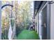 Condo balcony with an artificial grass rug and porch swing at 6851 Roswell Rd # I18, Sandy Springs, GA 30328