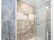 Close-up of glass-enclosed shower with tile design at 6851 Roswell Rd # I18, Sandy Springs, GA 30328