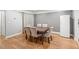 Well-lit dining room with hardwood floors, a dining table, and six chairs at 6851 Roswell Rd # I18, Sandy Springs, GA 30328