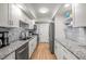 Well-lit kitchen with granite countertops, stainless steel appliances, and wooden floors at 6851 Roswell Rd # I18, Sandy Springs, GA 30328