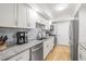 Bright kitchen featuring granite countertops, stainless appliances, and white cabinetry at 6851 Roswell Rd # I18, Sandy Springs, GA 30328