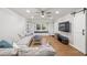 Bright living room with large sectional, hardwood floors, and barn door access at 6851 Roswell Rd # I18, Sandy Springs, GA 30328