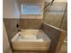 Modern bathroom featuring a soaking tub, glass shower, and neutral tile surround at 330 Piedmont Cir, Covington, GA 30016