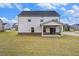 Backyard with a covered patio and a lush green lawn, perfect for outdoor enjoyment and entertaining at 467 Daffodil Ln, Mcdonough, GA 30253