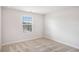 Well-lit bedroom with neutral walls and plush carpet, featuring window overlooking neighborhood at 467 Daffodil Ln, Mcdonough, GA 30253