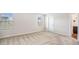 Well-lit bedroom with neutral walls and plush carpet, showcasing windows and a door to the bathroom at 467 Daffodil Ln, Mcdonough, GA 30253