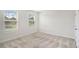 Bedroom features neutral walls and carpet, with natural light streaming through the windows at 467 Daffodil Ln, Mcdonough, GA 30253