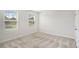 Bright bedroom with a double window and neutral carpet at 467 Daffodil Ln, Mcdonough, GA 30253