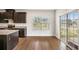 Modern kitchen featuring dark cabinets, stainless steel appliances, granite countertops, and sliding glass doors at 467 Daffodil Ln, Mcdonough, GA 30253
