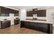 Modern kitchen with dark cabinetry, granite countertops, stainless steel appliances, and a functional island at 467 Daffodil Ln, Mcdonough, GA 30253