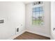 Bright laundry room with vinyl flooring, a window for natural light, and washer/dryer hookups at 467 Daffodil Ln, Mcdonough, GA 30253