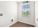 Bright laundry room with wood-look flooring and window at 467 Daffodil Ln, Mcdonough, GA 30253