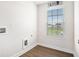 Functional laundry room with a window and ample space for appliances and storage at 467 Daffodil Ln, Mcdonough, GA 30253