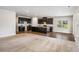 Spacious open-concept layout with kitchen island, dark cabinetry, and flowing hardwood floors into living area at 467 Daffodil Ln, Mcdonough, GA 30253