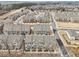 Aerial view of a residential community featuring well-maintained townhomes and landscaped streets at 4145 Essex Pond Way, Cumming, GA 30040