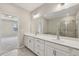 Primary bathroom with double sink vanity, large mirrors, and a glass shower at 4145 Essex Pond Way, Cumming, GA 30040