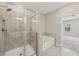 Bathroom featuring a large tiled shower and separate soaking tub at 4145 Essex Pond Way, Cumming, GA 30040